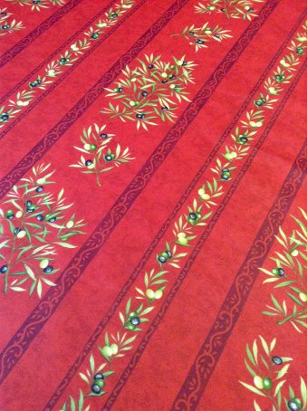 red provencal coated tablecloth with olives designs