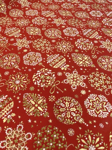 large Christmas tablecloth with gold baubles on a red fabric