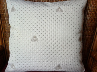 pique cushion with bees design