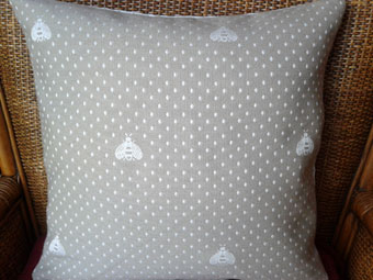 pique cushion with bees design