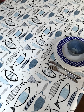 blue and white coated tablecloth with fish designs